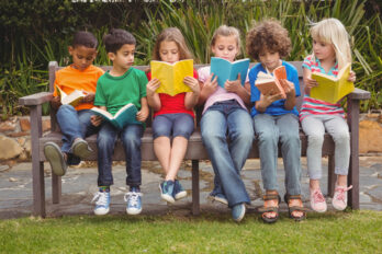 Children,Reading,From,Books,Together,While,Sitting,Down