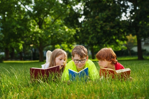 Cute,Children,Reading,Colorful,Books,Together,Outside,In,The,Park.