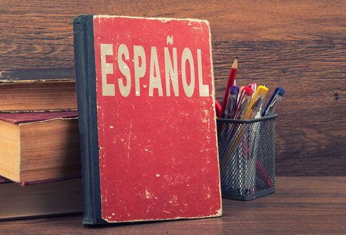 Learn,Spanish,Concept.,Book,On,A,Wooden,Background