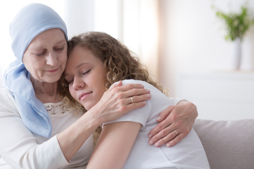 Daughter,Hugging,Sick,Elderly,Mother,With,Cancer,Wearing,A,Blue
