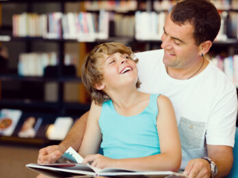 Father,With,Son,In,Library,With,Books