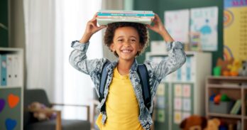 Child,,Face,And,Book,On,Head,In,School,Classroom,For