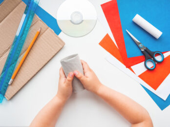 Child,Makes,Eco-friendly,Toy,Of,Colored,Paper,And,Used,Toilet