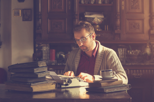 Young,Man,Writing,On,Old,Typewriter.
